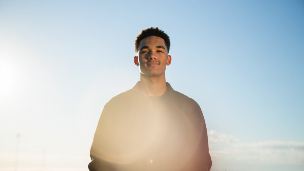Person representing Prajwal name traits like brightness, leadership, and positivity with a glowing aura.